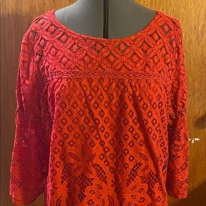 Red lace top with red camisole underneath.